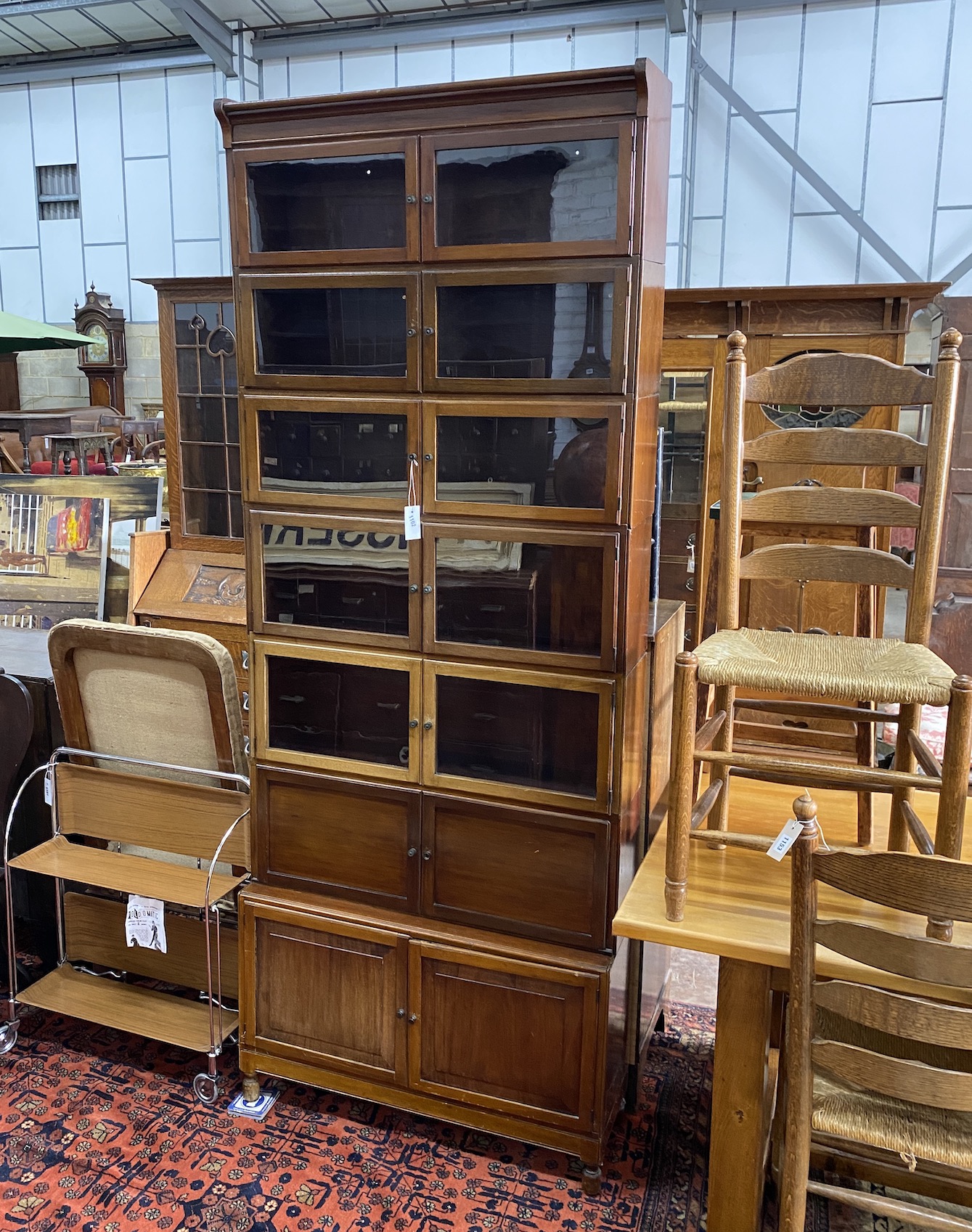 A Globe Wernicke style mahogany seven section secretaire bookcase, length 89cm, depth 29cm, height 230cm